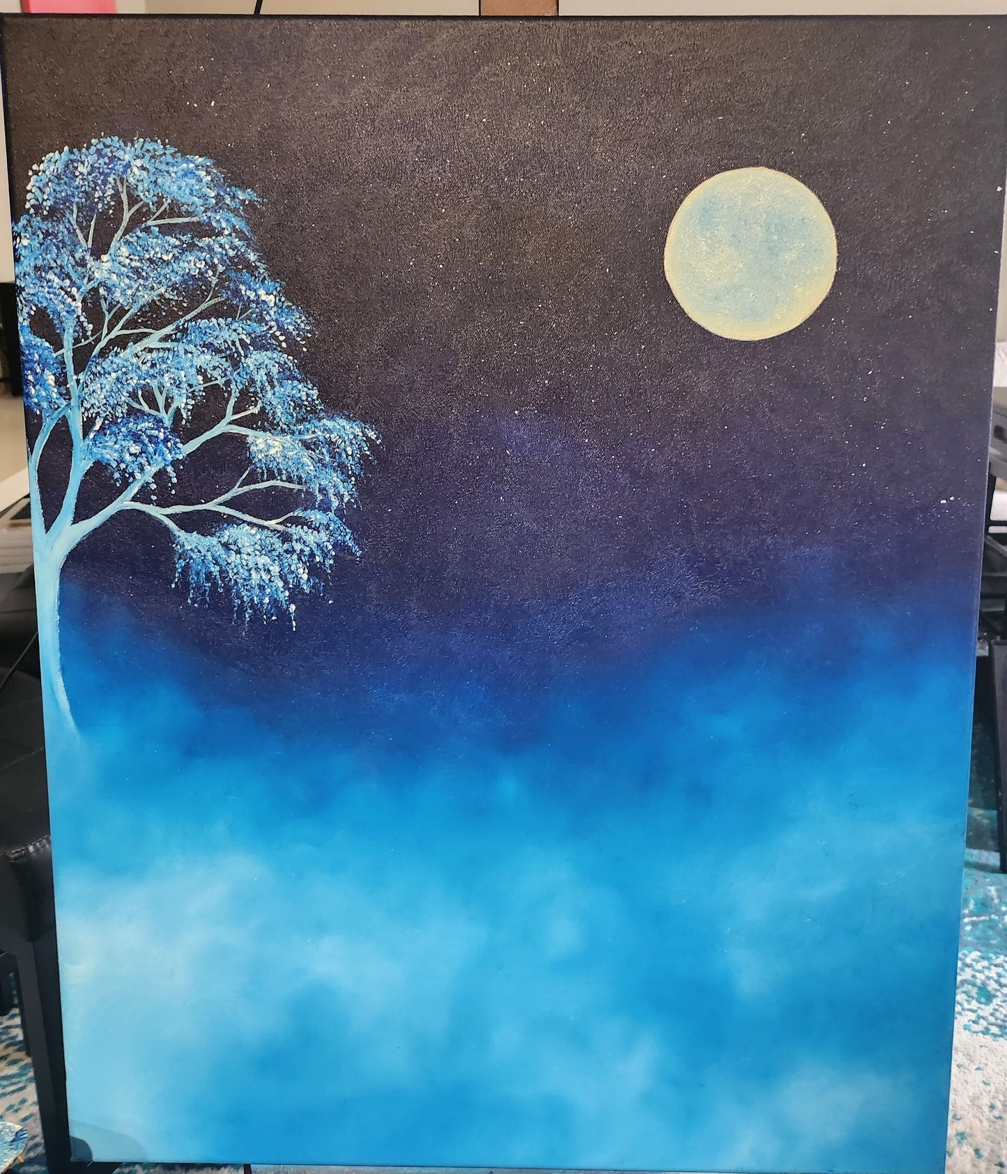 Painting fo a tree standing on the left in the mist against a dark night sky and full moon