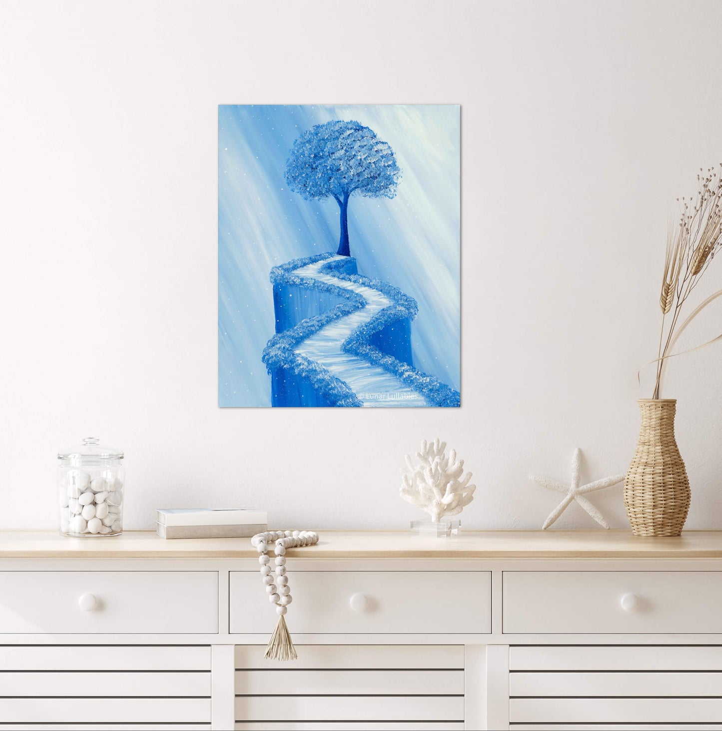 Mockup: Blue tree and path on a white wall above a wooden console table.