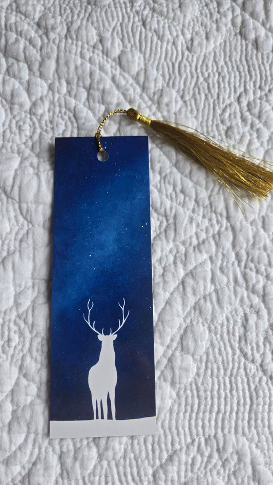 Blue bookmark with white silhouette design on textured fabric background