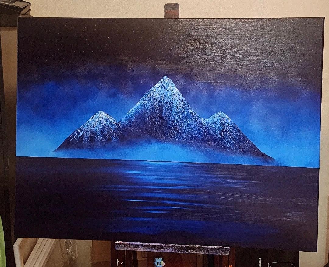 Hushabye Mountain Original Painting: Painting of a blue mountain range on an easel.