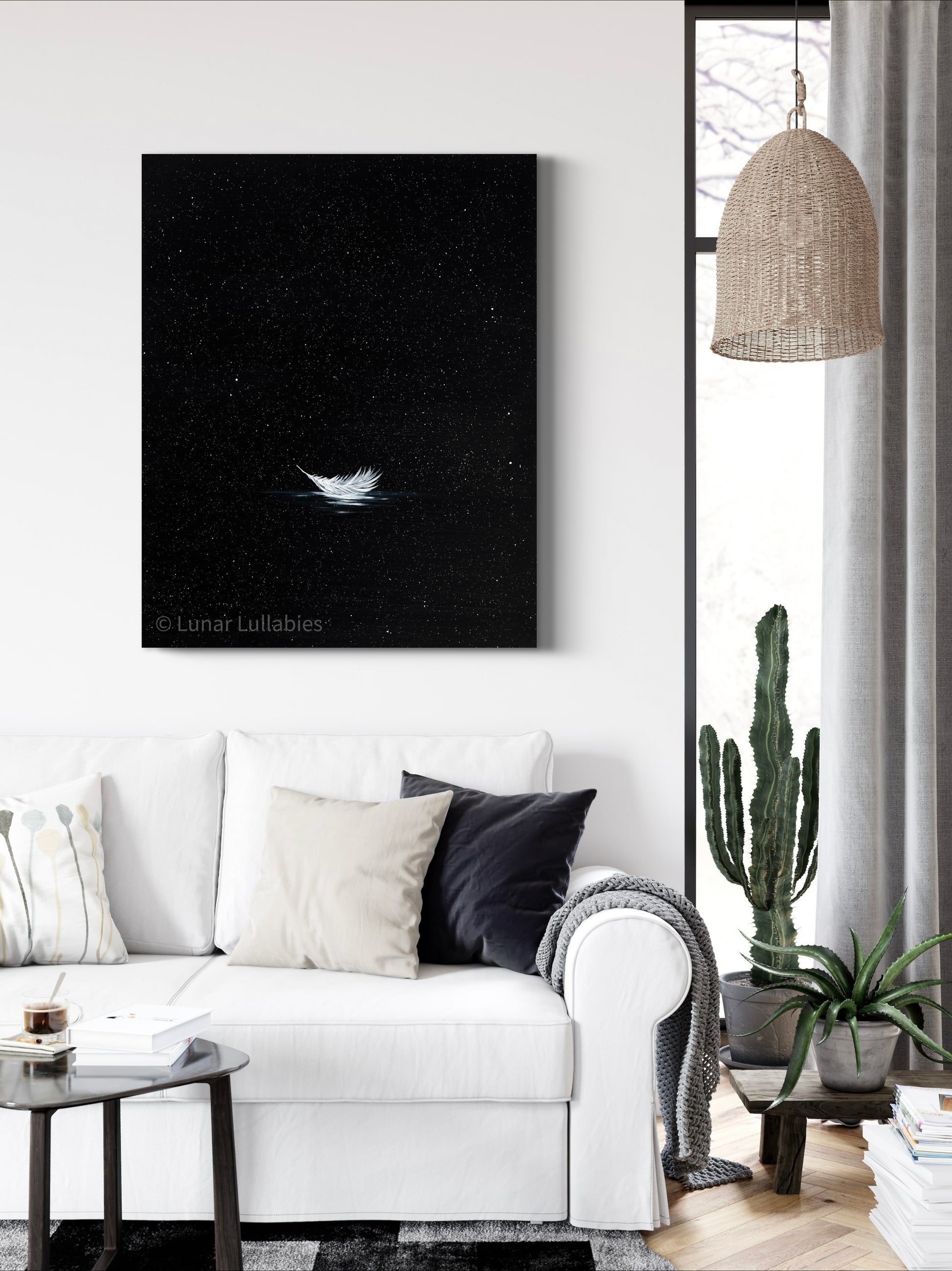 Mockup: Modern living room with a black and white painting on the wall, a white sofa, and decorative plants.
