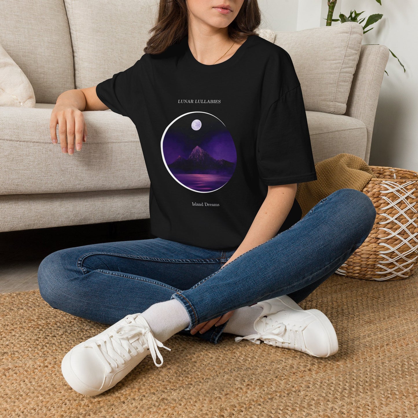 Women wearing a black t-shirt with a graphic design sitting on the floor.