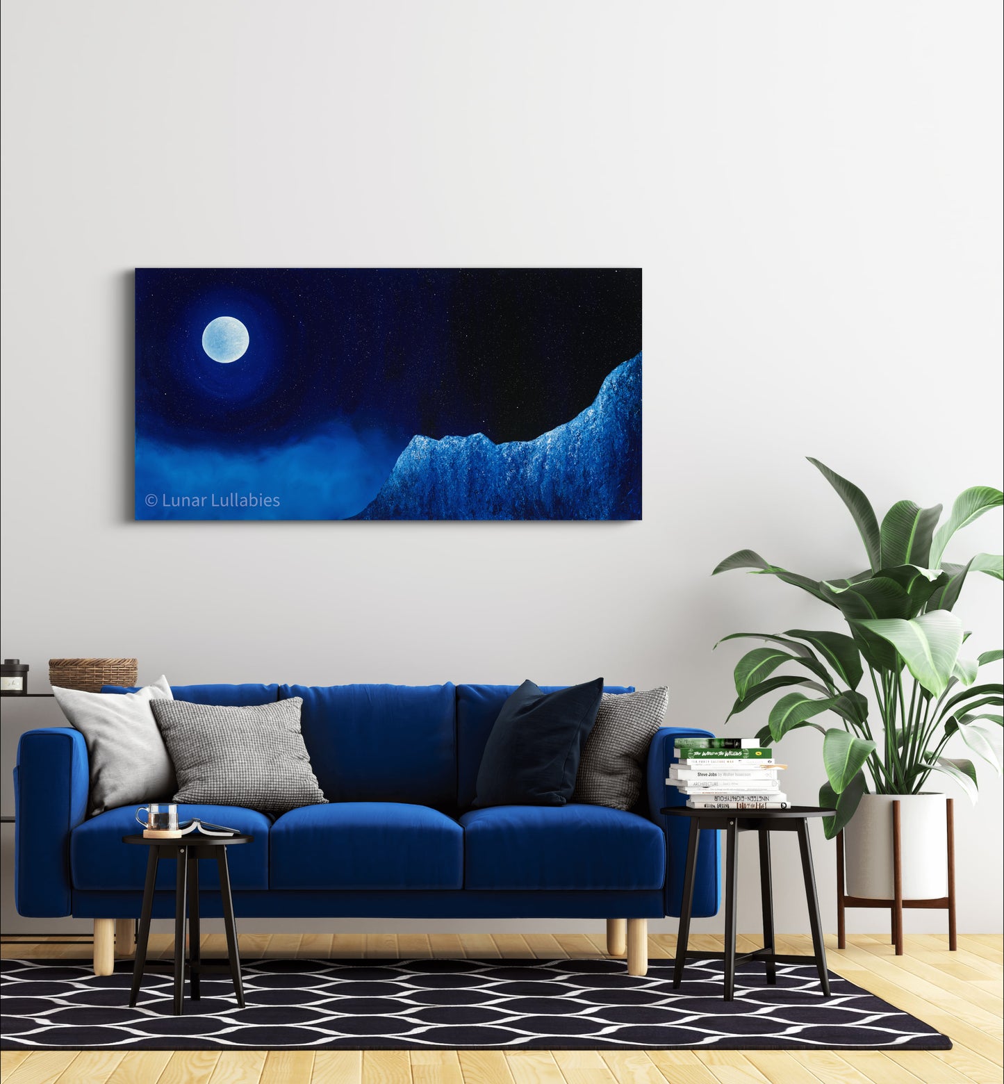 Mockup: Blue sofa in a living room with a large wall art piece depicting a night sky with a moon and mountain.