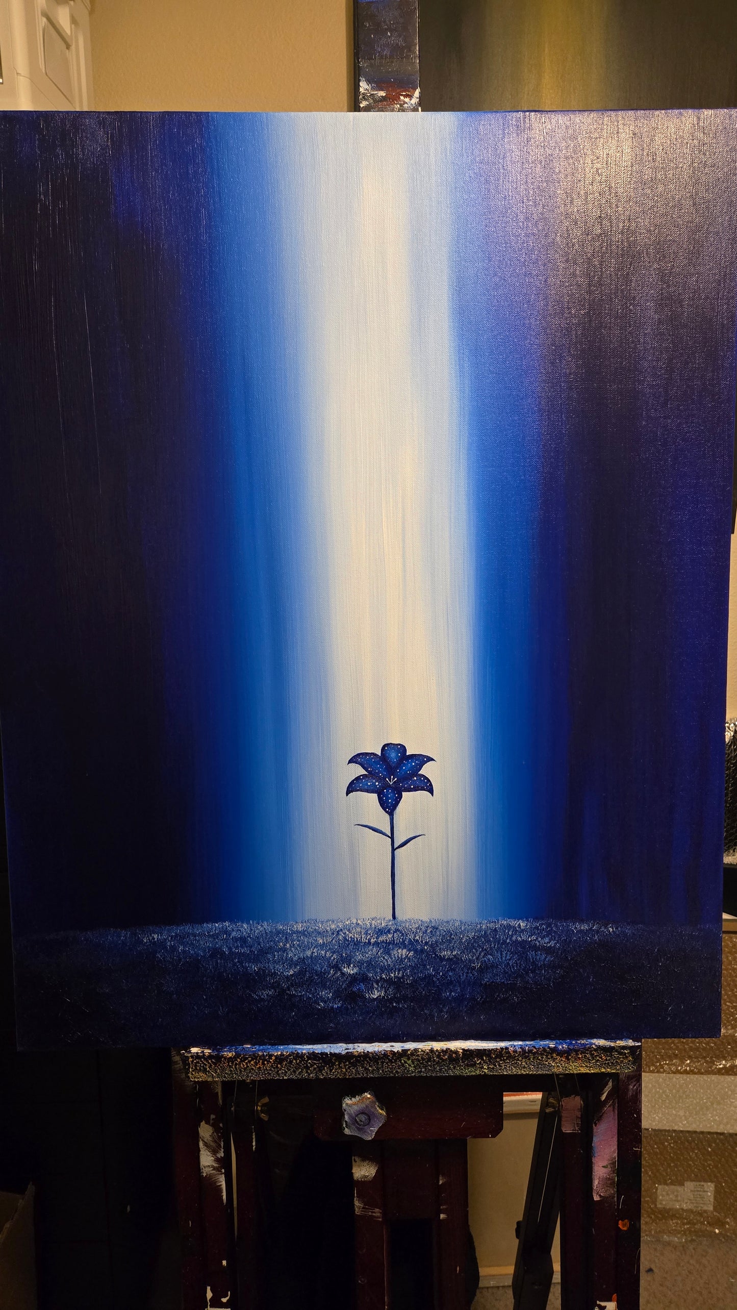 Painting on an easel of a Nightbloom flower against a blue background with a light ray of light shining down. 