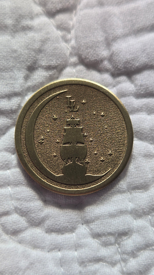 Bronze coin with embossed design on a textured white surface