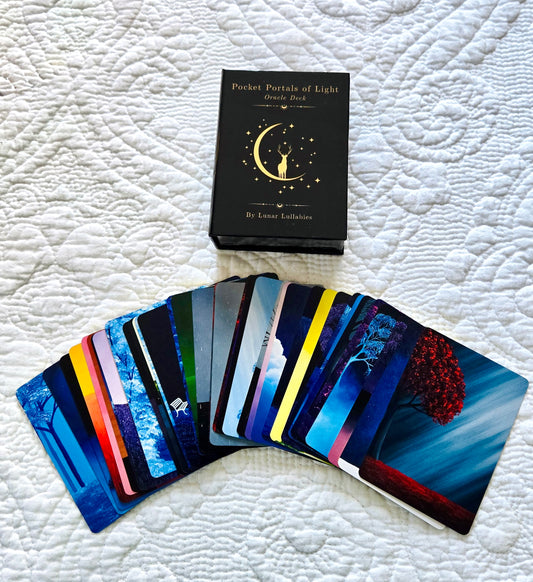 Set of oracle cards with a box labeled 'Pocket Portals of Light' on a textured white surface.