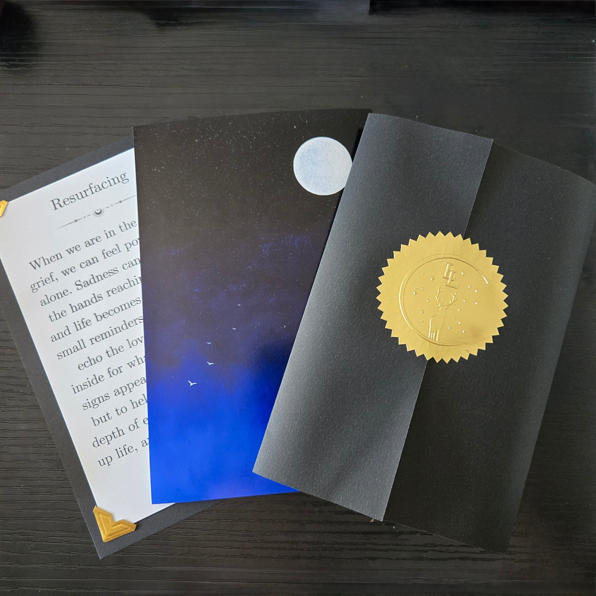 Message card, 4x6 inch print, and vellum seal with seal on a black table top
