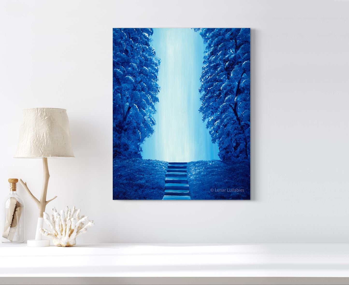 Mockup: Artwork of a blue forest scene on a white wall.