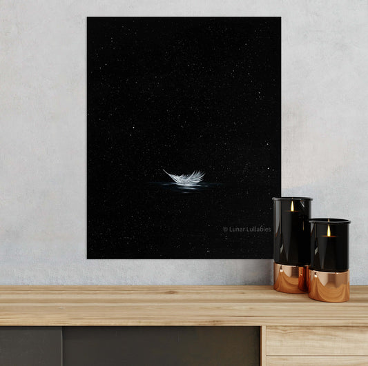 Artwork of a feather against a starry night sky on a wall above a wooden surface with two candles.