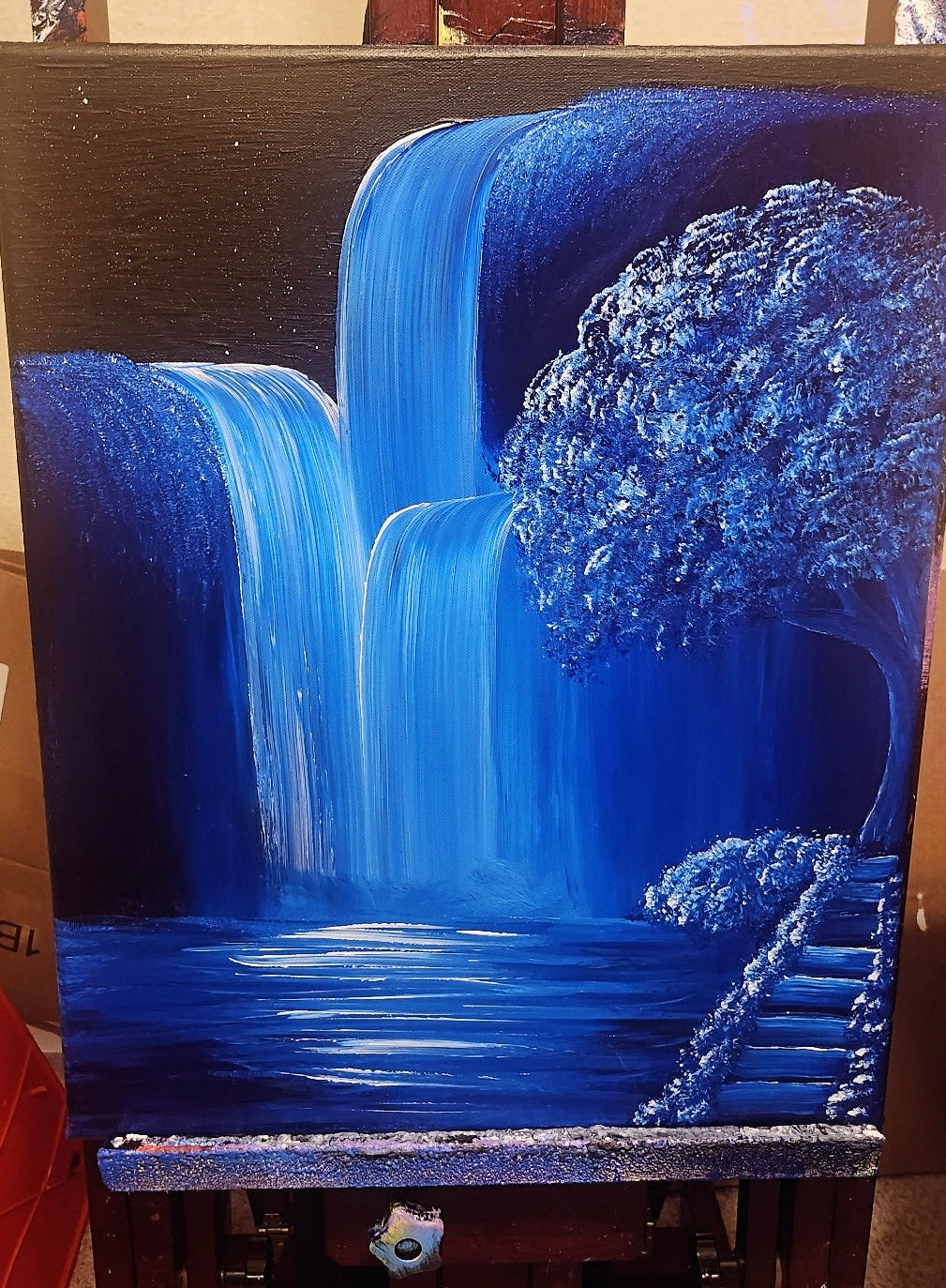 Blue waterfall painting on an easel