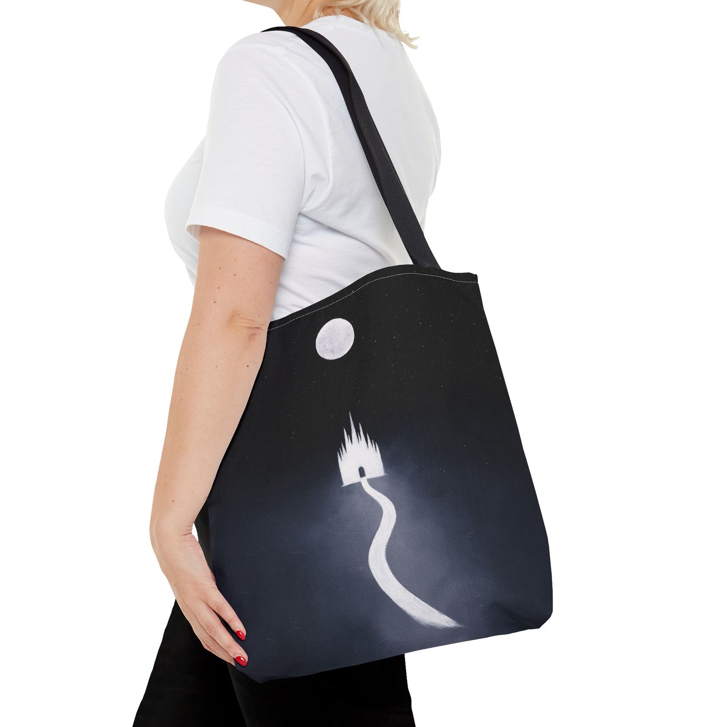 Person wearing a black tote bag with a white design on a white background